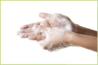 A woman washing her hands with a soap suds