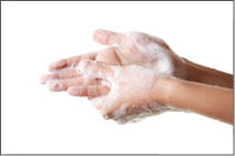 A woman washing her hands with a soap suds