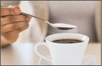 USA, New Jersey, Jersey City, Close-up of woman sweetening coffee